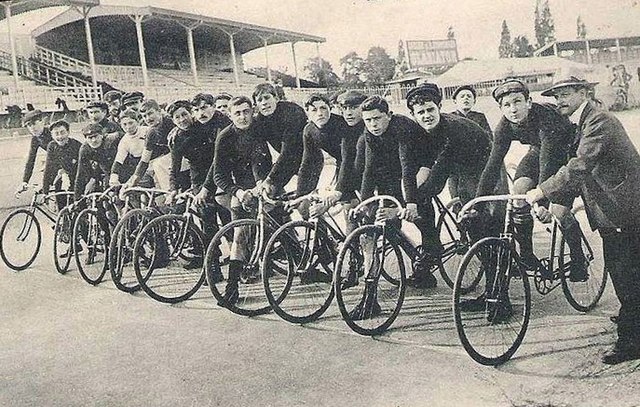 A lineup of men on bicycles