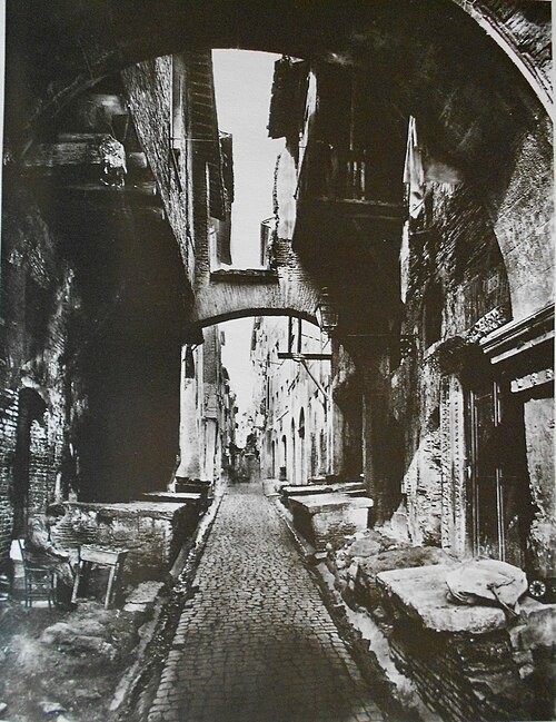 The old fish market ("La Pescheria") in via del Portico d'Ottavia (c. 1860). The marble slabs where the fish was sold are visible on both sides of the