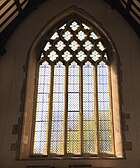 The West Window is of 5 lights in a decorated style with reticulated tracery West window Greyfriars Reading.jpg