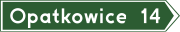 E-4 „drogowskaz w kształcie strzały do miejscowości podający do niej odległość”