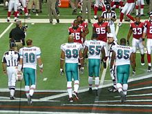 Ferguson (#95) with fellow 2009 Dolphins team captains Jason Taylor, Joey Porter and Chad Pennington. 2009 Miami Dolphins team captains.jpg