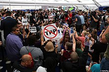 Protesting Sanders supporters storm a media tent 2016 Democratic Convention protesters at media center.jpg