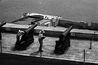 Guns of the Saluting Battery in the foreground, with the RML 9-inch gun emplacement at Lascaris Battery in the background 2 Saluting battery 080917 Ilford Delta 100.jpg
