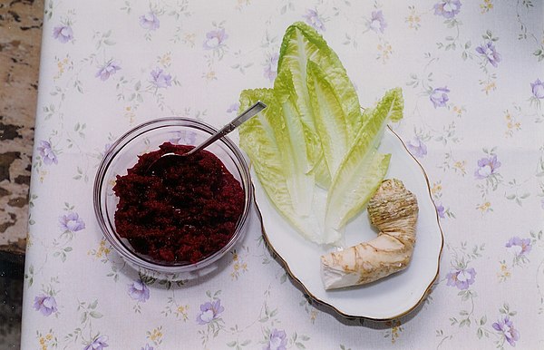 Grated horseradish mixed with cooked beets (known as chrein), romaine lettuce, and horseradish root, which should be freshly grated