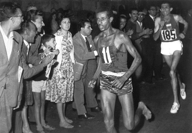 Abebe Bikila of Ethiopia wins the marathon barefooted