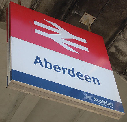 The double-arrow symbol signifies a railway station or the rail network throughout Britain. It appears prominently on all stations as well as road signs and maps.