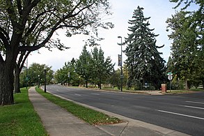 The Alamo Placita neighborhood is named for Alamo Placita Park. The street in the foreground is the northbound part of Speer Boulevard. Alamoplacita.JPG