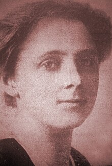 Close-up of a young woman with relatively short hair; she is gazing directly at the camera.