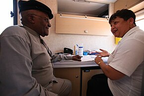 Archbishop Desmond Tutu gets an HIV test on the Desmond Tutu HIV Foundation's Tutu Tester, a mobile test unit. Archbishop Desmond Tutu gets an HIV test on The Desmond Tutu HIV Foundation's Tutu Tester, a mobile test unit that brings healthcare right to your doorstep.jpg