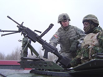 A soldier of the 174th Infantry Brigade trains a reservist on convoy duty at Fort Drum, New York. Army mil-2006-12-14-093550.jpg