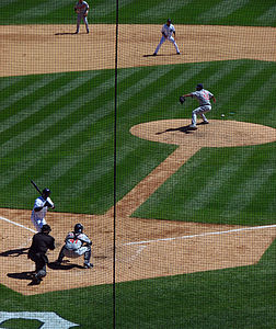 A baseball game through a mesh screen