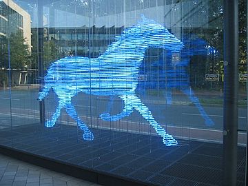 Blue neon lighting, first used in commercial advertising, is now used in works of art. This is Zwei Pferde für Münster (Two horses for Münster), a neon sculpture by Stephan Huber (2002), in Munster, Germany.