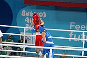 Deutsch: Boxen bei den Olympischen Jugendspielen 2018 Tag 12, 18. Oktober 2018 - Kampf um Bronze im Leichten Weltergewicht Jungen – Hassan Azim (Großbritannien, rot) schlägt Mohammed Boulaouja (Marokko, blau) RSC; Ringrichter ist Wulfren Olivares Peréz (Kolumbien). English: Boxing at the 2018 Summer Youth Olympics on 18 October 2018 – Bronze Medail Match Light Welterweight Boys - Hassan Azim (Great Britain, red) beats Mohammed Boulaouja (Morocco, blue) RSC; Referee is Wulfren Olivares Peréz (Columbia). Español: Boxeo en los Juegos Olímpicos Juveniles de Verano de 2018 en 18 de octubre de 2018 - Medalla de bronce de los hombres ligeros de peso welter: Hassan Azim (Gran Bretaña, rojo) vence a Mohammed Boulaouja (Marruecos, azul) RSC; El árbitro es Wulfren Olivares Peréz (Colombia).