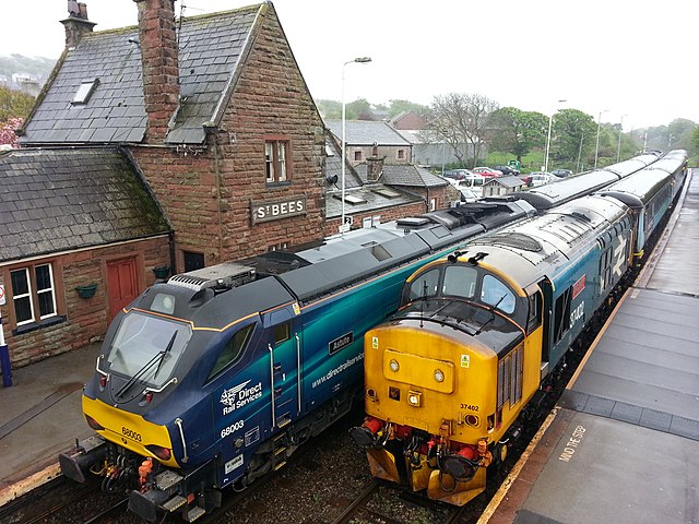 DRS Class 37 and Class 68 cross with Mark 2 passenger stock at St Bees on the Cumbrian Coast line.