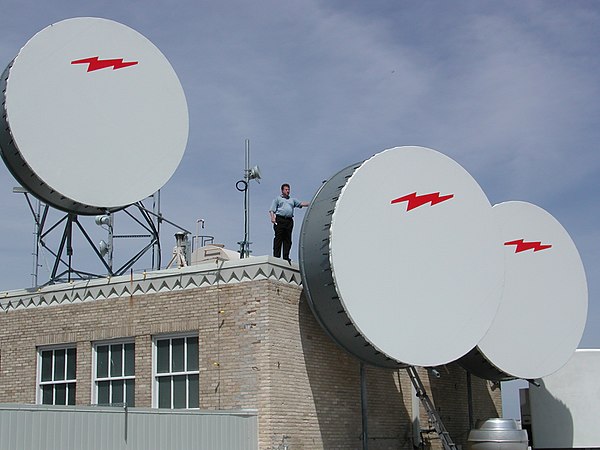 Three fixed wireless dishes with protective covers on top of 307 W. 7th Street, Fort Worth, Texas, around 2001