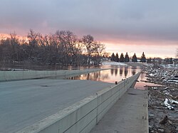 A low-water crossing in Fargo, North Dakota, United States of America during a routine flooding event on the Red River of the North. The water level was at 29.5', just below the threshold for a major flood as defined by the National Weather Service. Fargo-Moorhead Troll Bridge during 2023 Spring Flood.jpg