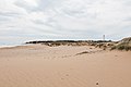 Vista lejana del faro desde la playa de Tarifa.