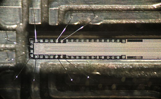 The chip in a fax machine. Only about one quarter of the length is shown. The thin line in the middle consists of photosensitive pixels. The read-out circuit is at left.