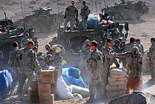 U.S. Army soldiers unload humanitarian aid from their Strykers in the town of Rajan Kala, Afghanistan, 2009.