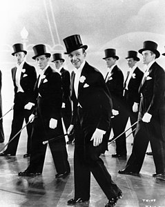 Fred Astaire and backup dancers in the 1935 film Top Hat, dressed in white tie.