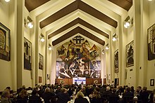 Rostrum end of the Great Hall, showing artworks by Leonard French (Regeneration, 1972) and some from The Journey series (1974). Great Hall ANU.jpg