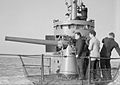 The gun's crew going into action with the 3 inch gun while the Commanding Officer watches from the conning tower of HMSM Sunfish whilst she was at Portsmouth. - 4 November 1943