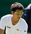 Hiroki Moriya competing in the first round of the 2015 Wimbledon Qualifying Tournament at the Bank of England Sports Grounds in Roehampton, England. The winners of three rounds of competition qualify for the main draw of Wimbledon the following week.