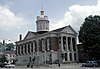 Red courthouse with white columns and a tall cupola