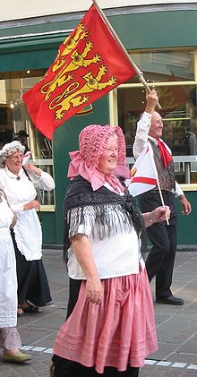 Performers in traditional Jersey costume at a cultural festival Jersey folk costume parade.jpg