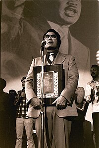 Rev. Jim Jones receives a Martin Luther King Jr. Humanitarian award at Glide Memorial Church in San Francisco, January 1977. Jim Jones, 1977.jpg