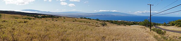 A view of the Kohala Coast and adjacent volcanoes, taken from the slopes of Kohala Mountains about 6 miles (10 km) northwest of Kawaihae. From left to