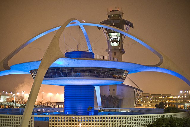 The illuminated exterior of the Theme Building at night