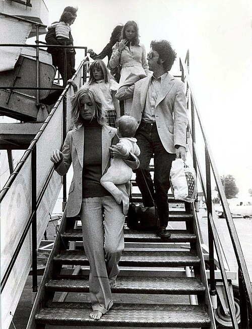 Wings arriving in Finland, August 1972: Linda McCartney is seen carrying baby Stella