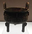 Bronze round tripod with animal mask decoration