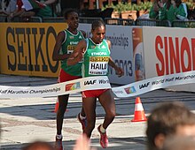 A footrace is an authentic norm-referenced test. The point of the race is to see who runs the fastest, rather than to see whether everyone can run at a certain speed. Meseret Hailu wins the women's race at the 2012 World Half Marathon Championships in Kavarna, Bulgaria.jpg