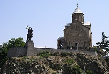 Ryttarstaty av Wachtang Gorgassalis framför Metekhi Church i Tbilisi