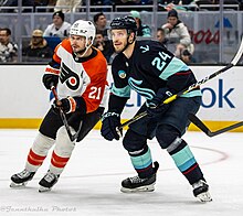 Laughton (left) battles for position against Jamie Oleksiak of the Seattle Kraken in 2023. Philadelphia Flyers at Seattle Kraken - December 29, 2023 - Jamie Oleksiak and Scott Laughton (53431068592).jpg
