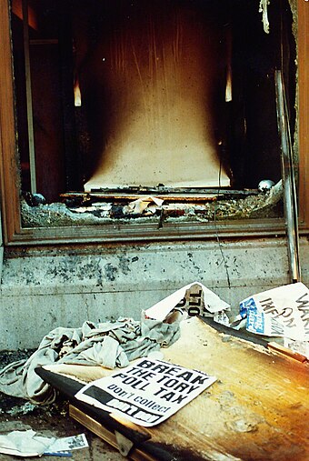 Damage, including a broken shop window, caused during the rioting on Trafalgar Square.