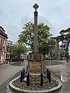 Stone column with a cross at the top.