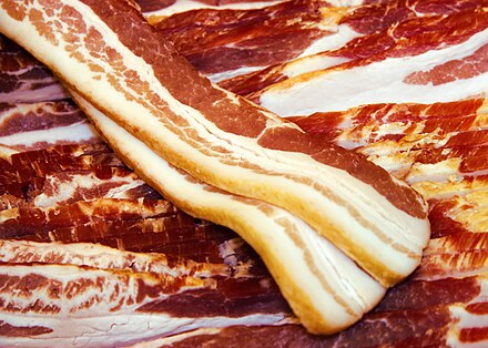 Uncooked strips of side bacon