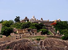 Vindyagiri summit area with Gommateshwara statue in the background, Odegal basadi in foreground. Shravanabelagola Hillview.jpg