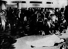 First responders attend to stampede victims outside Cincinnati's Riverfront Coliseum. Stampede victim covered, The Cincinnati Post 1979-12-04 page 1.jpg