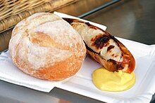 A grilled veal sausage served with bread and mustard Street Sausage.jpg