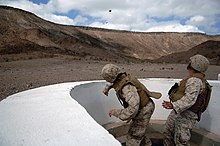 Grenade immediately after being thrown at a practice range. The safety lever has separated in mid-air from the body of the grenade. US Navy 080123-F-1644L-044 A Marine assigned to the 3rd Low Altitude Air Defense Battalion, throws a M-67 Fragment Grenade at the firing range.jpg