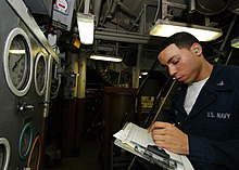 A Machinist's Mate takes readings in the engine room of the multi-purpose amphibious assault ship USS Iwo Jima. US Navy 080926-N-4236E-014 Machinist's Mate 3rd Class Jason Ferrante takes readings in the engine room.jpg