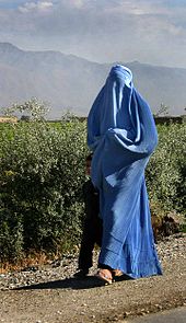 A woman with burqa on walking by the road in northern Afghanistan Woman walking in Afghanistan.jpg