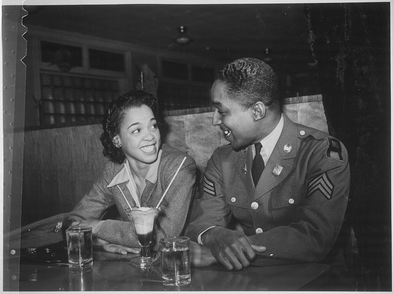 File:"Sgt. Franklin Williams, home on leave from army duty, with his best girl Ellen Hardin, splitting a soda. They met at Do - NARA - 535838.jpg