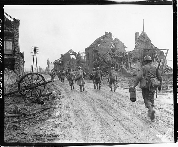 American infantrymen of Company I, 121st Infantry Regiment move through Hurtgen, Germany, on their way to the front lines, December 1944.