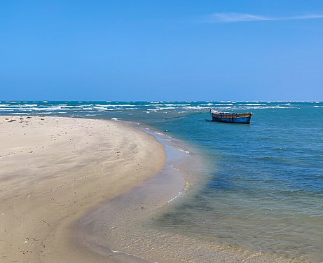 A boat in still waters of the ghost town of Dhanushkodi, India