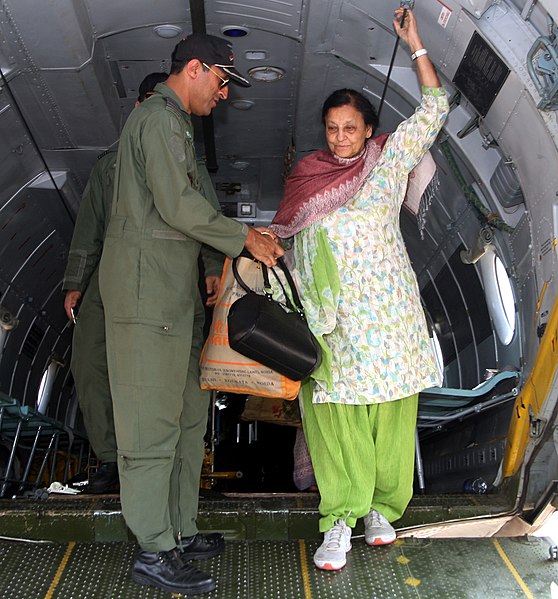 File:A rescued old woman from Nepal is being de-boarded at Palam Airport from a Transport Aircraft by Indian Air Force officials on April 28, 2015.jpg